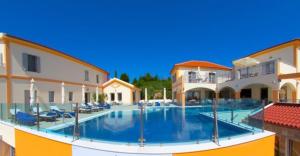 a large swimming pool in the middle of a building at Belle View Hotel - Sea View & Sunset in Mánganos