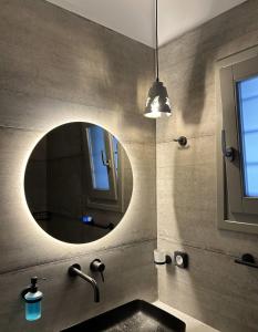 a bathroom with a sink and a mirror at SOPHILIA SUITES in Koufonisia