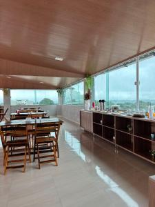 uma sala de jantar com mesas de madeira e um balcão em Hotel Carvalho em Ibiapina