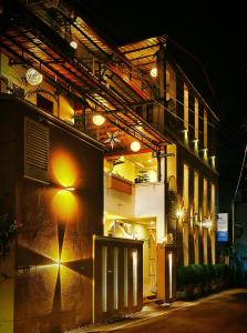 a building with lights on the side of it at night at Serenity Sands Beach Resort in Puducherry