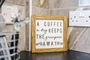 een bord dat zegt een koffie per dag houdt de brompot een manier bij Stunning 3-Bedroom House Sleeps 8 in Liverpool