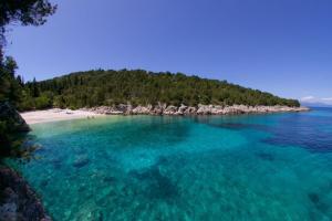 an island in the middle of a body of water at Belle View Hotel - Sea View & Sunset in Mánganos