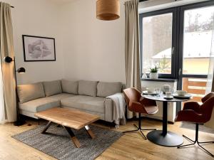 a living room with a couch and a table at Apartment Loft Lomnica in Tatranská Lomnica