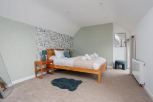 a bedroom with a bed and a mirror in it at Old Stable Cottage in Stoborough