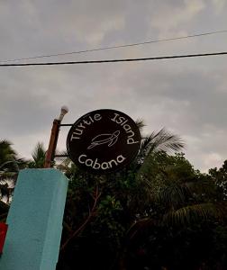 a sign for a restaurant with a fish on it at Turtle Island Cabana in Tangalle