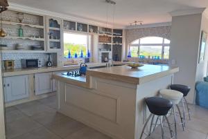 a kitchen with a large island with a counter top at Stone Crown Manor B&B in Diasstrand +31 photos