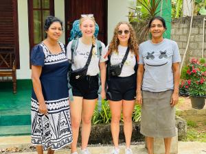 a group of women standing next to a pool at Jm Resort in Dambulla