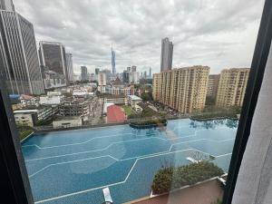 a view of a large swimming pool in a city at Sentral Luxury Suites KL in Kuala Lumpur