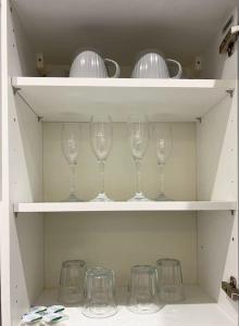 a row of wine glasses sitting on shelves at Warm 1-bedroom London apartment in London