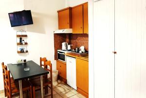 a kitchen with a table and a stove top oven at Pension Antonakis in Ouranoupoli