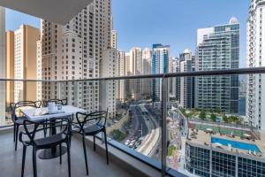 a balcony with a table and chairs and a city at GuestReady - Out of the Blue in Dubai