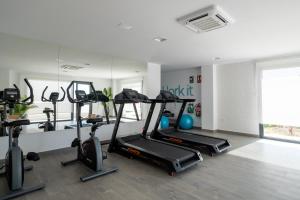 a gym with several treadmills and elliptical machines at Residencial Celere Playa Niza in Almayate Bajo