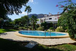 a swimming pool in the middle of a yard at Floridasol in Denia