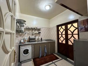 a kitchen with a washing machine and a washer at Spacious fantastic closeby airport and city in Marrakesh
