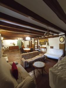 a large living room with couches and a table at Ca la Paula in Pla del Panadés