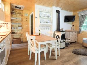 a dining room with a table and chairs in a kitchen at Geofond Chaty in Chotěboř