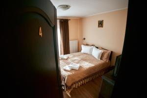 a bedroom with a bed with two towels on it at Casa MagicPlace in Viile Satu Mare +33 photos