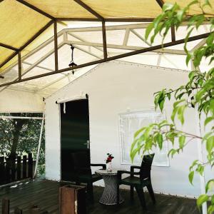 a patio with a table and chairs and a tent at THE CANVAS LONAVLA in Lonavala