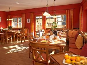 a living room with a table and a dining room at Chalet Alpinum in Sankt Anton am Arlberg