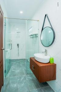 a bathroom with a sink and a mirror at Daline Private Homestay in Kampot