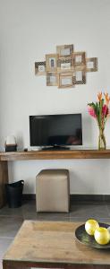 a living room with a television and a table at Marina golf in Saint-François