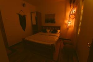 a bedroom with a bed in a dark room at KACHINS Homes in Coonoor