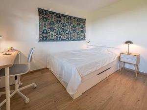 a bedroom with a bed and a desk and a desk at New & Stylish Studio in prime location in Lausanne