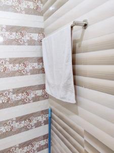 a towel hanging on a towel rack in a bathroom at Morbex Guest House Islamabad in Islamabad