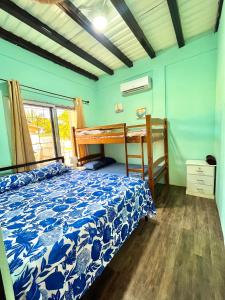 a bedroom with a bed and a bunk bed at Casa Tela in Tela