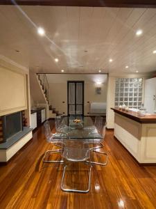 a living room with a glass table and a kitchen at Loft Carlotta in Viareggio