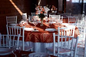 a long table with white chairs and a table with glasses at Casa MagicPlace in Viile Satu Mare