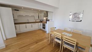 a kitchen and dining room with a table and chairs at Trippett Cottage in Saint Breward