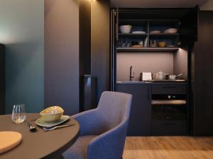 a dining room with a table and a blue chair at Hotel am Sophienpark in Baden-Baden