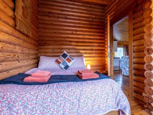 a bedroom with a bed in a log cabin at 2 Bed in Clovelly 00371 in Clovelly
