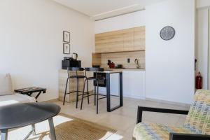 a kitchen and living room with a table and chairs at Lighthouse apartments in Alexandroupoli