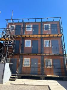 a large brick building with a fire escape at Residencial Oasis Container in Calama