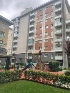 a playground in front of a large apartment building at Квартира в центре Стамбула in Istanbul