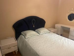 a bedroom with a bed with a black head board at Квартира в центре Стамбула in Istanbul
