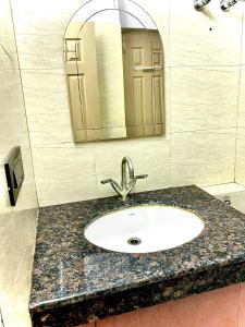 a bathroom counter with a sink and a mirror at Homestay-a better living in Lucknow