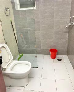 a bathroom with a toilet and a shower with a bucket at Homestay-a better living in Lucknow