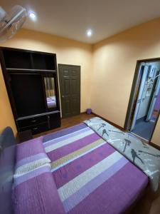 a bedroom with a bed and a flat screen tv at Frosty Hills Homestay in Tanah Rata +3 photos