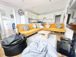a living room with a couch and a table at MUST VIEW - Slick Retreat in Holloway - Next to Emirates Stadium - Sleeps up to 6 in London