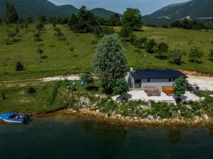 an aerial view of a house on an island in the water at ''Lake House Jana'' Ramsko Jezero in Prozor