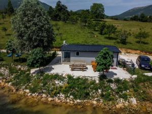 an aerial view of a small house in a field at ''Lake House Jana'' Ramsko Jezero in Prozor +16 photos
