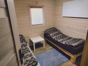 Kleines Zimmer mit einem Bett und einem Fenster in der Unterkunft Domki Przydwórz 