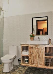 a bathroom with a toilet and a sink and a mirror at Nusa Sedayu Hotel By Ocean View in Nusa Penida