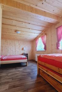 a room with two beds in a wooden cabin at Chaloupka U Matušků in Varnsdorf