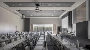 a room with rows of tables and chairs at MOVE Hotels Venezia Nord in Mogliano Veneto