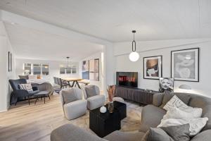 a living room with a couch and chairs and a table at Venture Vacations - Best Possible Location-Laugavegur Luxury Loft in Reykjavík