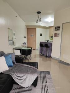 - un salon avec un canapé et une table dans l'établissement 1 Bedroom Deluxe in Parañaque, à Manille
